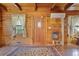 Inviting living room with hardwood floors, wood paneled walls and windows dressed with light and airy curtains at 154 Knucklesville Rd, Rydal, GA 30171