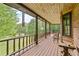 Relax on this covered porch offering scenic views, perfect for enjoying the outdoors in comfort at 154 Knucklesville Rd, Rydal, GA 30171