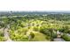 Scenic aerial view of a lush golf course with mature trees and the city skyline in the distance at 1740 Doncaster Ne Dr, Atlanta, GA 30309
