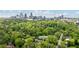 Aerial view of 1740 Doncaster Dr NE surrounded by lush greenery and downtown Atlanta skyline at 1740 Doncaster Ne Dr, Atlanta, GA 30309