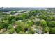 Aerial view of a wooded neighborhood close to a highway and a city skyline in the distance at 1740 Doncaster Ne Dr, Atlanta, GA 30309