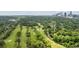 Expansive aerial shot of a golf course with tree-lined fairways, set against the backdrop of a city skyline at 1740 Doncaster Ne Dr, Atlanta, GA 30309
