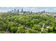 Scenic aerial view of Atlanta skyline peeking through lush greenery of a residential neighborhood at 1740 Doncaster Ne Dr, Atlanta, GA 30309