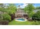 Aerial view of backyard featuring mature trees, inground pool, hot tub, and a large deck at 1740 Doncaster Ne Dr, Atlanta, GA 30309