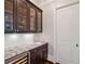 Chic bar area with wine fridge, sink, granite countertops, and upper cabinets at 1740 Doncaster Ne Dr, Atlanta, GA 30309