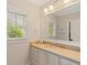 Bright bathroom featuring a single sink vanity, natural light, and granite countertops at 1740 Doncaster Ne Dr, Atlanta, GA 30309