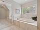 Luxurious marble bathroom featuring a soaking tub and a separate shower area at 1740 Doncaster Ne Dr, Atlanta, GA 30309