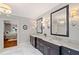 Elegant bathroom with double vanities, marble countertops, decorative sconces and a chandelier at 1740 Doncaster Ne Dr, Atlanta, GA 30309