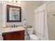 Bathroom with single sink, decorative framed mirror, and shower-tub combo at 1740 Doncaster Ne Dr, Atlanta, GA 30309