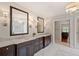 Elegant bathroom with double vanities, marble countertops, decorative sconces and a chandelier at 1740 Doncaster Ne Dr, Atlanta, GA 30309
