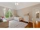 Bright bedroom showcasing a comfy bed, sofa, built-in storage, and large window at 1740 Doncaster Ne Dr, Atlanta, GA 30309