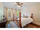 Relaxing bedroom with wooden bedframe, ceiling fan, natural light and hardwood floors at 1740 Doncaster Ne Dr, Atlanta, GA 30309