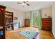 Spacious bedroom with hardwood floors, ceiling fan, and access to outdoor balcony at 1740 Doncaster Ne Dr, Atlanta, GA 30309