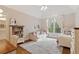 Cozy bedroom featuring a comfortable bed, sofa, bookshelves, and natural light at 1740 Doncaster Ne Dr, Atlanta, GA 30309