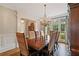 Formal dining room with large window, hardwood floors, elegant chandelier and seating for six at 1740 Doncaster Ne Dr, Atlanta, GA 30309