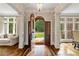 A grand foyer featuring hardwood floors, elegant lighting, and an open doorway to a beautifully landscaped front yard at 1740 Doncaster Ne Dr, Atlanta, GA 30309