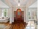 Elegant foyer features a beautiful wooden door, hardwood floors, and plenty of natural light at 1740 Doncaster Ne Dr, Atlanta, GA 30309