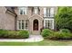 Inviting brick home with arched doorway and manicured shrubs at 1740 Doncaster Ne Dr, Atlanta, GA 30309
