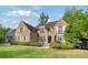 Beautiful brick house with manicured lawn and mature trees at 1740 Doncaster Ne Dr, Atlanta, GA 30309