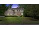 Charming brick home with a well-manicured front yard at dusk at 1740 Doncaster Ne Dr, Atlanta, GA 30309