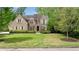 Elegant brick home with shuttered windows and lush landscaping at 1740 Doncaster Ne Dr, Atlanta, GA 30309