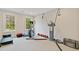 Bright home gym featuring fitness equipment, a workout bench, and large windows at 1740 Doncaster Ne Dr, Atlanta, GA 30309
