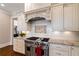 Up-close view of the kitchen, with stainless steel range, backsplash, and granite countertops at 1740 Doncaster Ne Dr, Atlanta, GA 30309