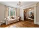 Cozy living room with hardwood floors, large windows, and a comfortable sofa at 1740 Doncaster Ne Dr, Atlanta, GA 30309