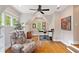 Attic office space with lots of natural light, hardwood floors, a ceiling fan, and a comfortable reading chair at 1740 Doncaster Ne Dr, Atlanta, GA 30309