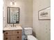 Stylish powder room features decorative wallpaper, mirror, vanity, and toilet at 1740 Doncaster Ne Dr, Atlanta, GA 30309