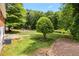 Expansive backyard featuring a level lawn, mature trees, and a charming wood deck perfect for outdoor enjoyment at 339 Diane Se Dr, Smyrna, GA 30082