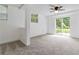 Bedroom with carpet, large window, and glass sliding doors to yard at 339 Diane Se Dr, Smyrna, GA 30082
