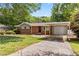 Attractive brick home featuring a carport, well-kept lawn, and a welcoming front entrance at 339 Diane Se Dr, Smyrna, GA 30082