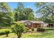 Beautifully landscaped front yard with a brick home, carport, and mature trees at 339 Diane Se Dr, Smyrna, GA 30082