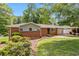 Charming brick home with a well-maintained lawn, mature trees, and a convenient carport at 339 Diane Se Dr, Smyrna, GA 30082