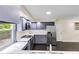 This kitchen features blue cabinets, stainless steel appliances, and marble countertops at 339 Diane Se Dr, Smyrna, GA 30082