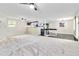 Open-concept living room with neutral carpet, ceiling fans, and a view into the kitchen at 339 Diane Se Dr, Smyrna, GA 30082