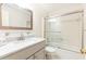 Bathroom featuring a tiled shower over tub, vanity and a large mirror at 3910 Ashford Lake Ne Ct, Brookhaven, GA 30319