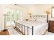 Bright bedroom featuring a wrought iron bed, French doors and hardwood floors at 3910 Ashford Lake Ne Ct, Brookhaven, GA 30319