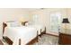 Bedroom with matching twin beds, stylish rug, hardwood floors and french doors at 3910 Ashford Lake Ne Ct, Brookhaven, GA 30319