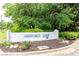 Ashford Lake community entrance sign surrounded by greenery and landscaping at 3910 Ashford Lake Ne Ct, Brookhaven, GA 30319
