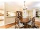 Traditional dining room showcasing hardwood floors, elegant furnishings, and convenient access to the kitchen at 3910 Ashford Lake Ne Ct, Brookhaven, GA 30319
