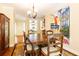 Dining room featuring a vintage table and chairs with charming decor and adjacent to a living space at 3910 Ashford Lake Ne Ct, Brookhaven, GA 30319
