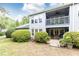 Home exterior with a balcony, patio and lush landscaping around the property at 3910 Ashford Lake Ne Ct, Brookhaven, GA 30319