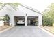Home exterior featuring a two-car garage with epoxy floors and overhead lighting at 3910 Ashford Lake Ne Ct, Brookhaven, GA 30319