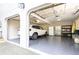 Two-car garage with epoxy floors, a refrigerator and storage shelves at 3910 Ashford Lake Ne Ct, Brookhaven, GA 30319