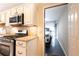 Modern kitchen featuring stainless steel appliances, granite countertops, and seamless access to the garage at 3910 Ashford Lake Ne Ct, Brookhaven, GA 30319