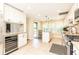 Spacious kitchen with stainless steel appliances, white cabinets, granite countertops, and ample natural light at 3910 Ashford Lake Ne Ct, Brookhaven, GA 30319
