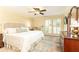 Serene bedroom featuring a large bed, shutters, and dresser, creating a peaceful retreat at 3910 Ashford Lake Ne Ct, Brookhaven, GA 30319