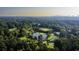 Overhead view of a community with lush trees surrounding a pond, golf course, and tennis courts at 143 Lablanc Nw Way, Atlanta, GA 30327